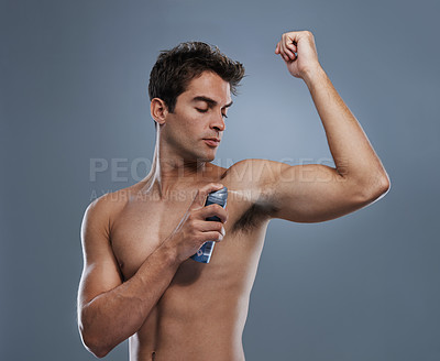 Buy stock photo Man, deodorant and spray for armpit or smell in studio or product application for clean odor, hygiene or grey background. Male person, topless and confidence or health wellness, care or mockup space