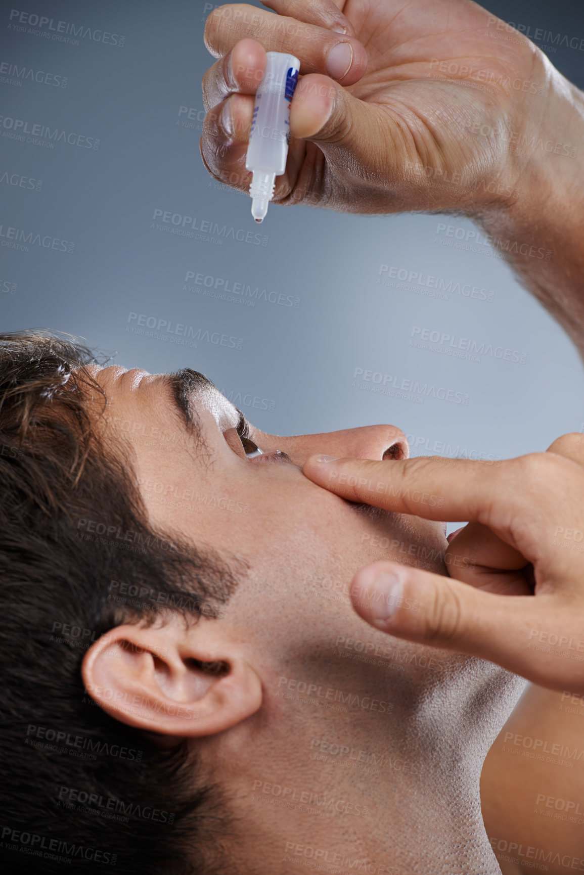 Buy stock photo Man, eye drops and vision for allergies or dropper in studio or healthcare wellness, liquid or grey background. Male person, solution and conjunctivitis for clean pupil or dry, irritation or mockup