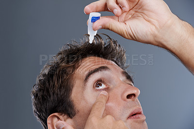 Buy stock photo Man, eye drops and vision for allergies or liquid in studio or healthcare wellness, dropper or grey background. Male person, solution and conjunctivitis for clean pupil or fluid, irritation or mockup