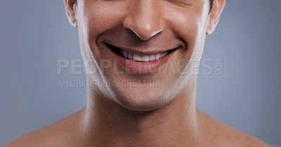 Buy stock photo Man, face and smile with skincare and lips with hygiene, jawline and satisfaction with treatment closeup. Grooming, confidence and mouth with young male model in studio background for cosmetic