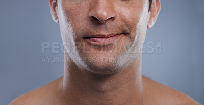 Buy stock photo Man, mouth and smirk with face and lips for hygiene, jawline, and unhappy for treatment closeup. Grooming, mockup space and skincare with male model in studio background for clean cosmetics zoom
