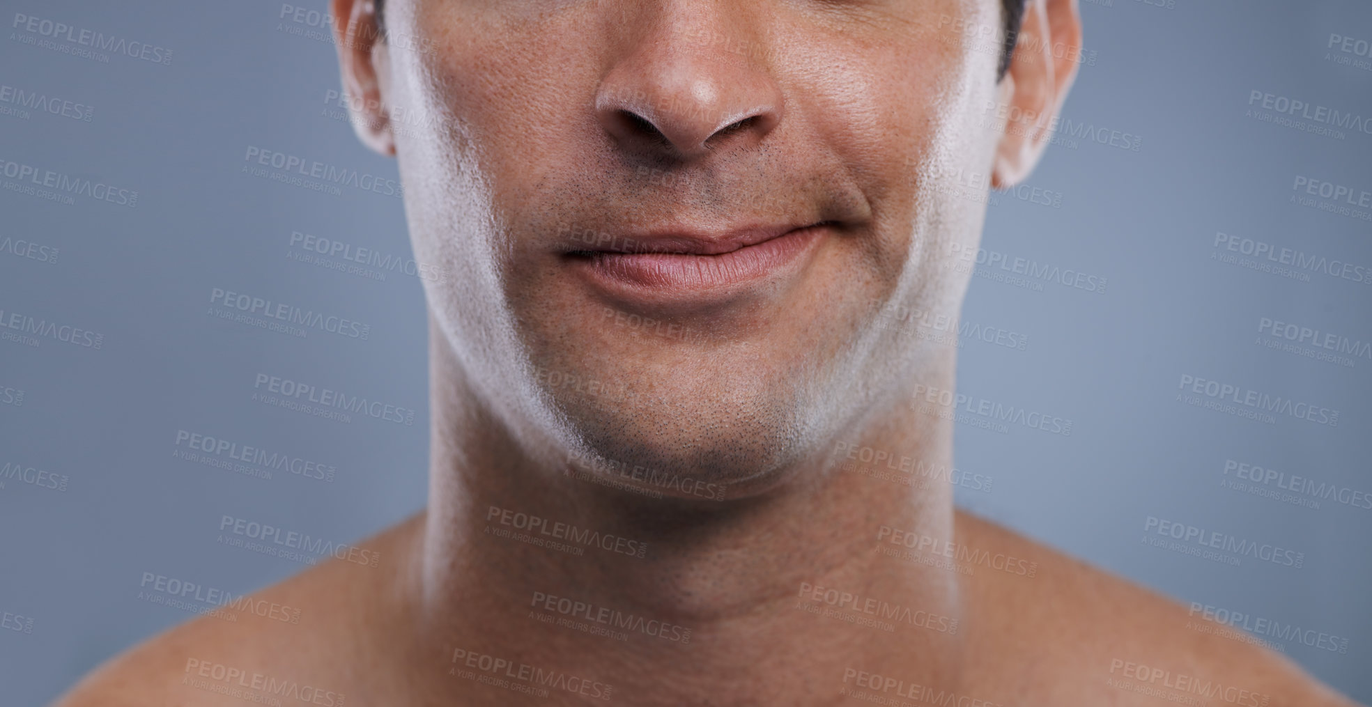 Buy stock photo Man, mouth and smirk with face and lips for hygiene, jawline, and unhappy for treatment closeup. Grooming, mockup space and skincare with male model in studio background for clean cosmetics zoom