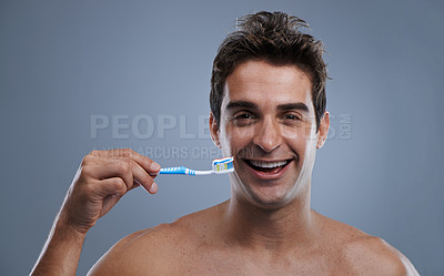 Buy stock photo Portrait, man or wellness with toothbrush, oral hygiene or body care on grey studio background. Face, person or model with fresh breath or health with toothpaste or morning routine with dental smile
