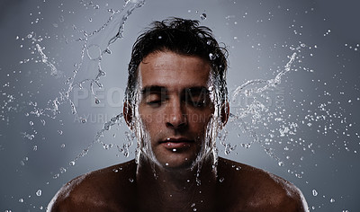 Buy stock photo Water splash, liquid and man wash face for bathroom routine, self care or beauty treatment. Eye closed, bathing and model headshot with hygiene, grooming and facial cleanse on dark grey background