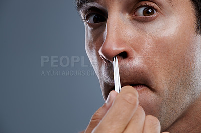 Buy stock photo Man, nose and hair with tweezers in studio on grey background for self care, wellness or dermatology. Male person, face and grooming for cosmetic beauty or healthy cleaning, wellbeing or mockup space