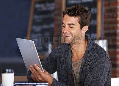 Buy stock photo Tablet, smile and young man in coffee shop doing research for creative freelance project. Happy, digital technology and male designer freelancer reading information on website for career in cafe.