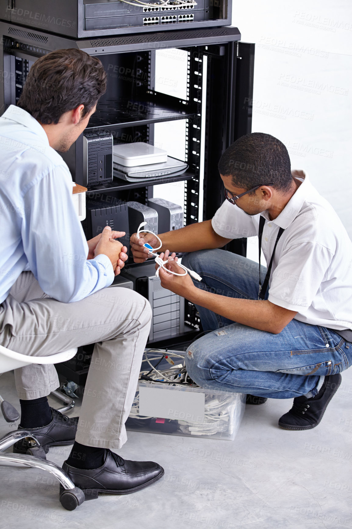 Buy stock photo Server room, man or electrician with working electronics for hardware maintenance or fixing glitch in office. IT support or worker with a technician or electrical engineer for information technology