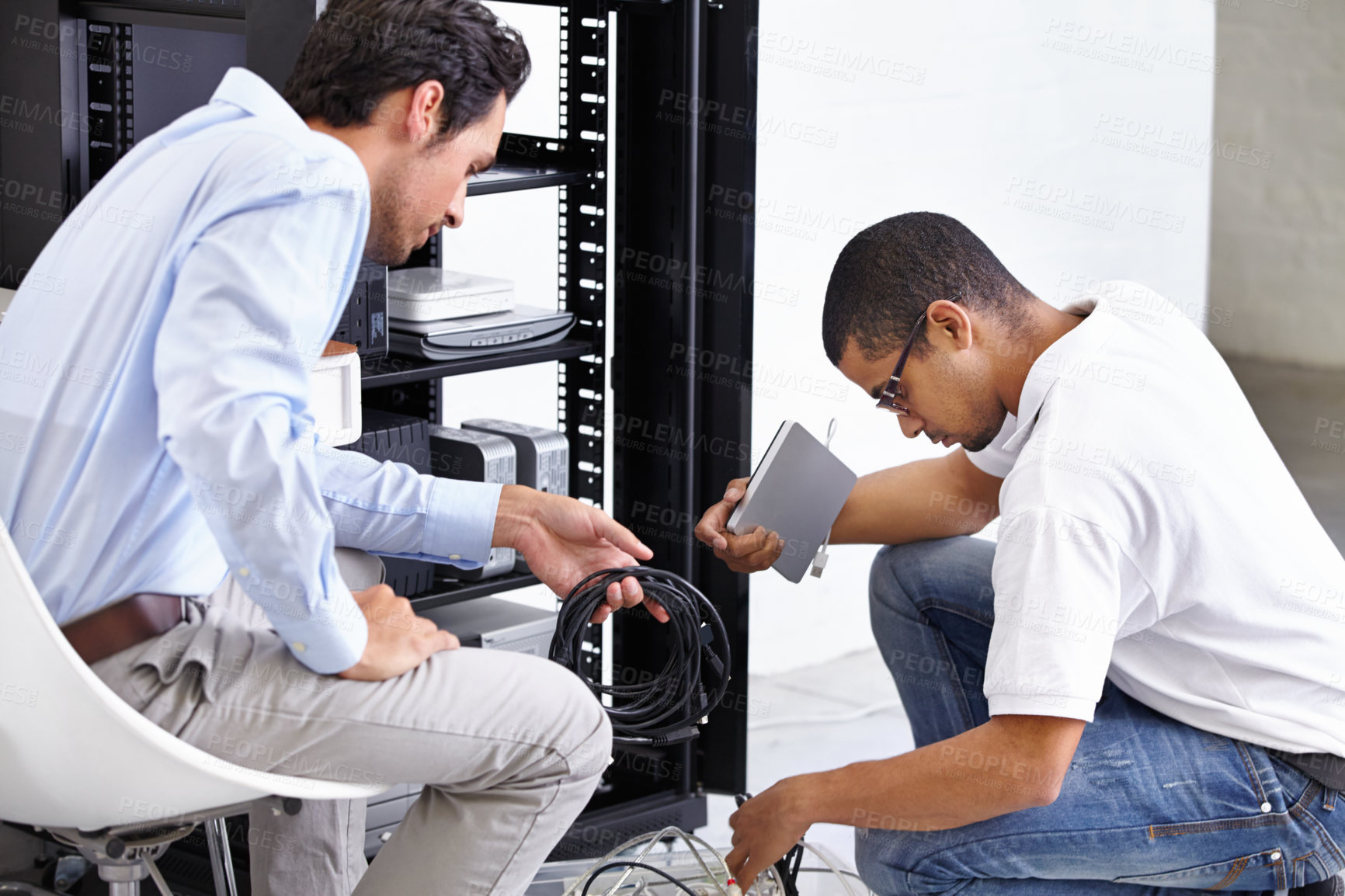 Buy stock photo Server room, man or technician fixing electronics for hardware maintenance or working on glitch in office. IT support or worker with an electrician or electrical engineer for information technology