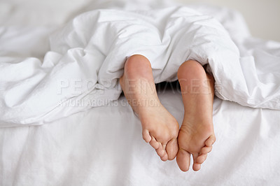 Buy stock photo Bed, foot and person sleeping in home, relax and resting nap in sheets for health, calm and leisure in the morning. Feet, bedroom and closeup of toes in blankets, skin of legs and comfort in house