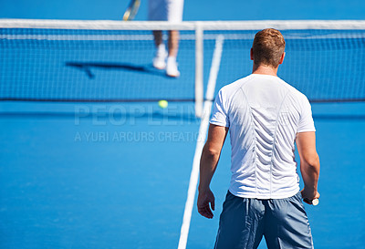 Buy stock photo Shot of two people playing tennis outside