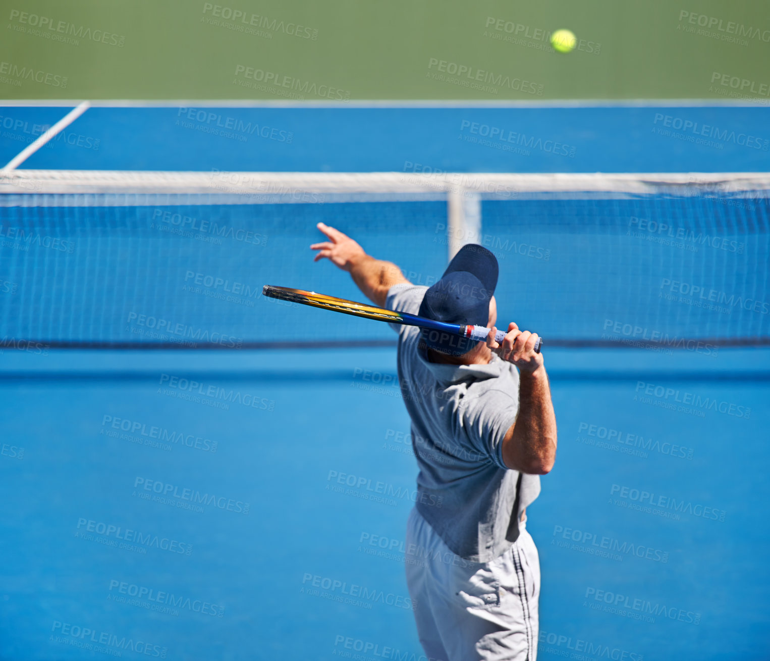 Buy stock photo Shot of a man trying to return a ball on a tennis court