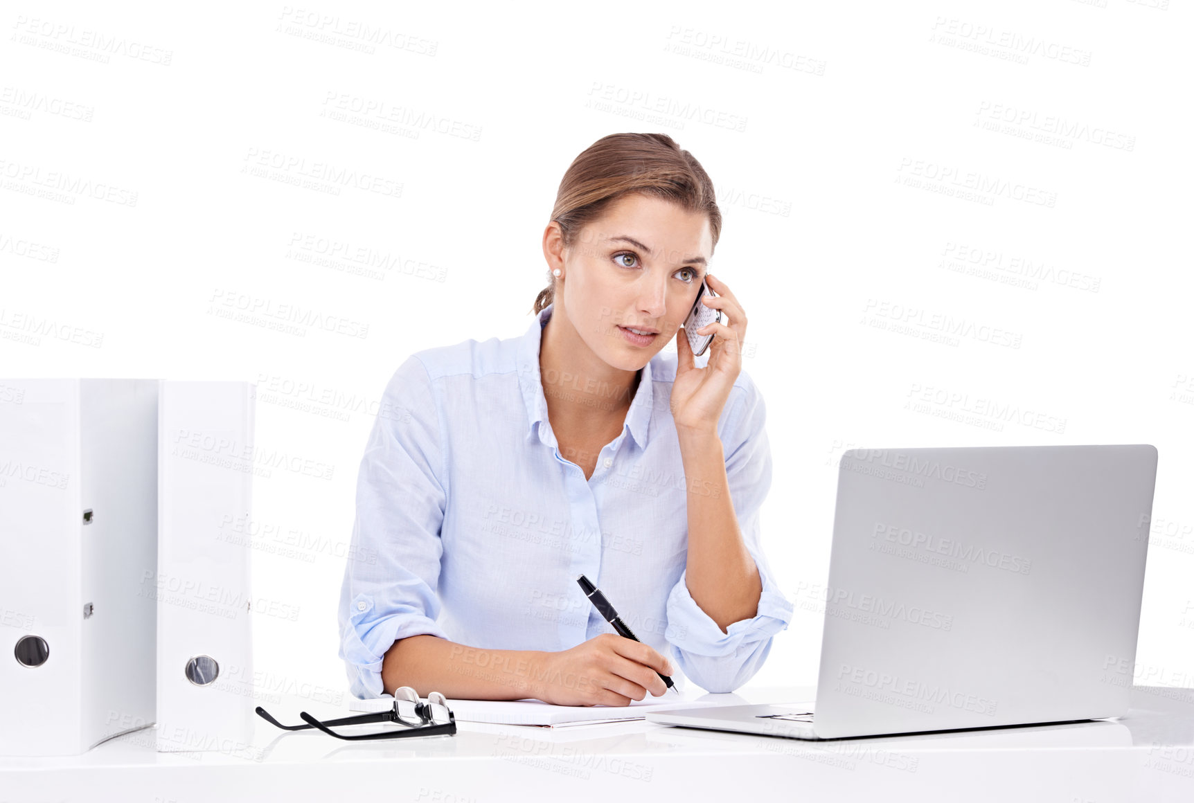 Buy stock photo An attractive young businesswoman talking on the phone and working on her laptop