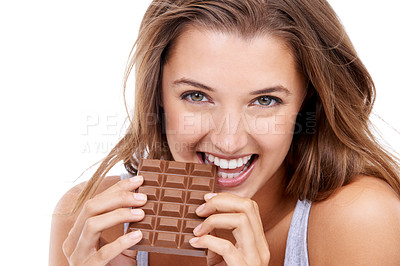 Buy stock photo An attractive young woman eating a slab of chocolate