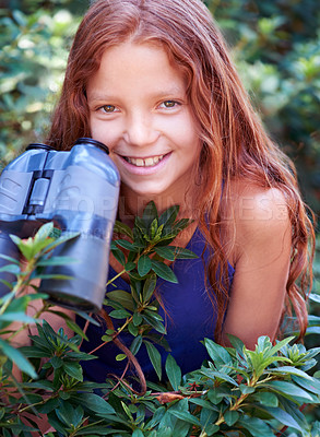 Buy stock photo Nature portrait, binocular and child smile for travel adventure, outdoor exploration or bird watching trip. Smile, tree leaves and face of kid on search journey in green forest, woods or eco jungle