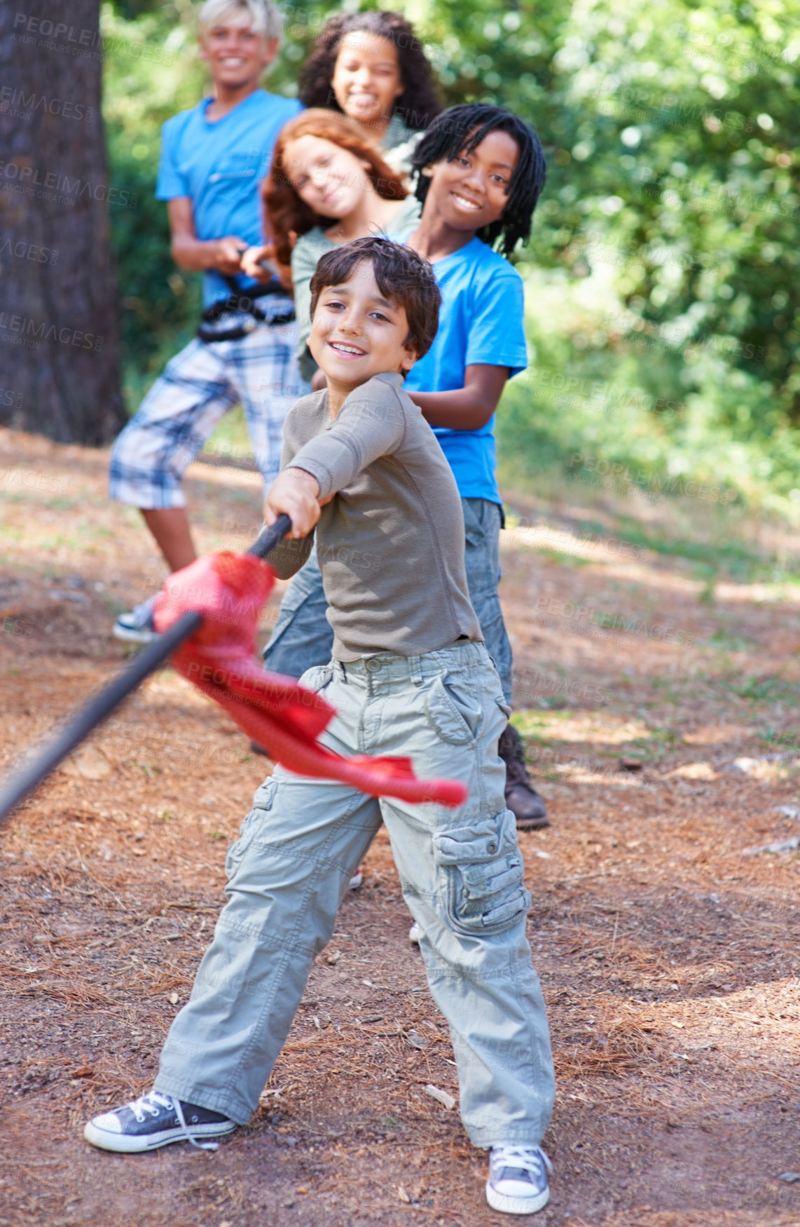 Buy stock photo Children, forest and tug of war for play adventure, challenge and strength game in woods with summer camping. Kids, diversity or competitive in outdoor environment for fresh air or happiness by trees