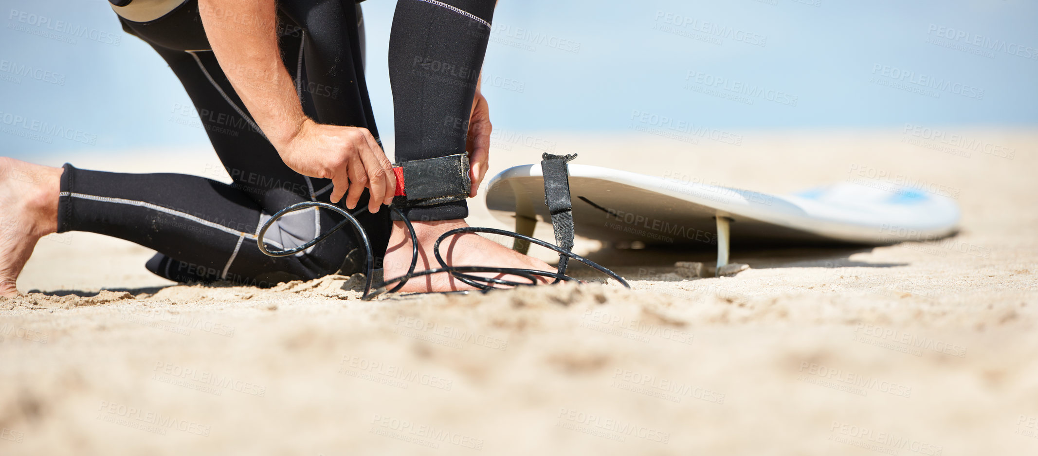 Buy stock photo Legs, strap for safety and surfer on beach for sports, fitness and training on travel vacation in summer. Hands, ankle and surfboard with person on sand by ocean or sea for surfing hobby or holiday