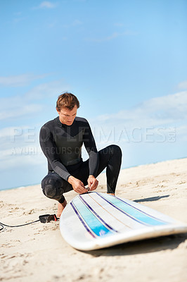 Buy stock photo Beach, man and surfboard rope outdoor in summer for exercise, fitness and workout. Surfer, wetsuit and person with leash by ocean for safety preparation, water sports and travel on holiday by sea