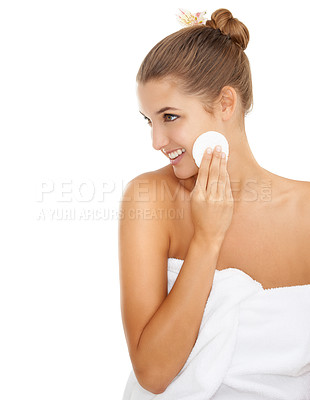 Buy stock photo Cropped shot of a gorgeous young woman wiping her face with a cotton swab against a white background