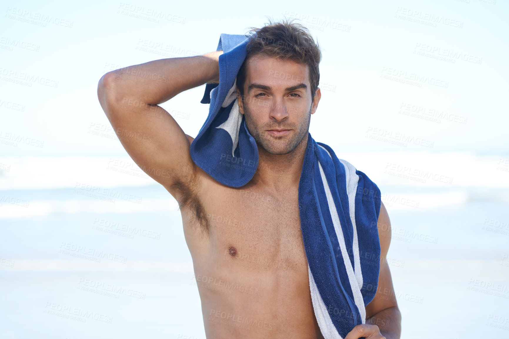 Buy stock photo Travel, beach and portrait of man with towel for swimming in ocean on vacation, holiday or adventure. Serious, handsome and young person by sea with confidence for summer weekend trip in Australia.