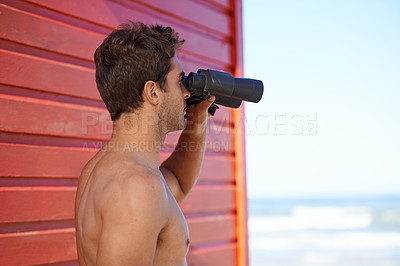 Buy stock photo A handsome young lifeguard at the beach
