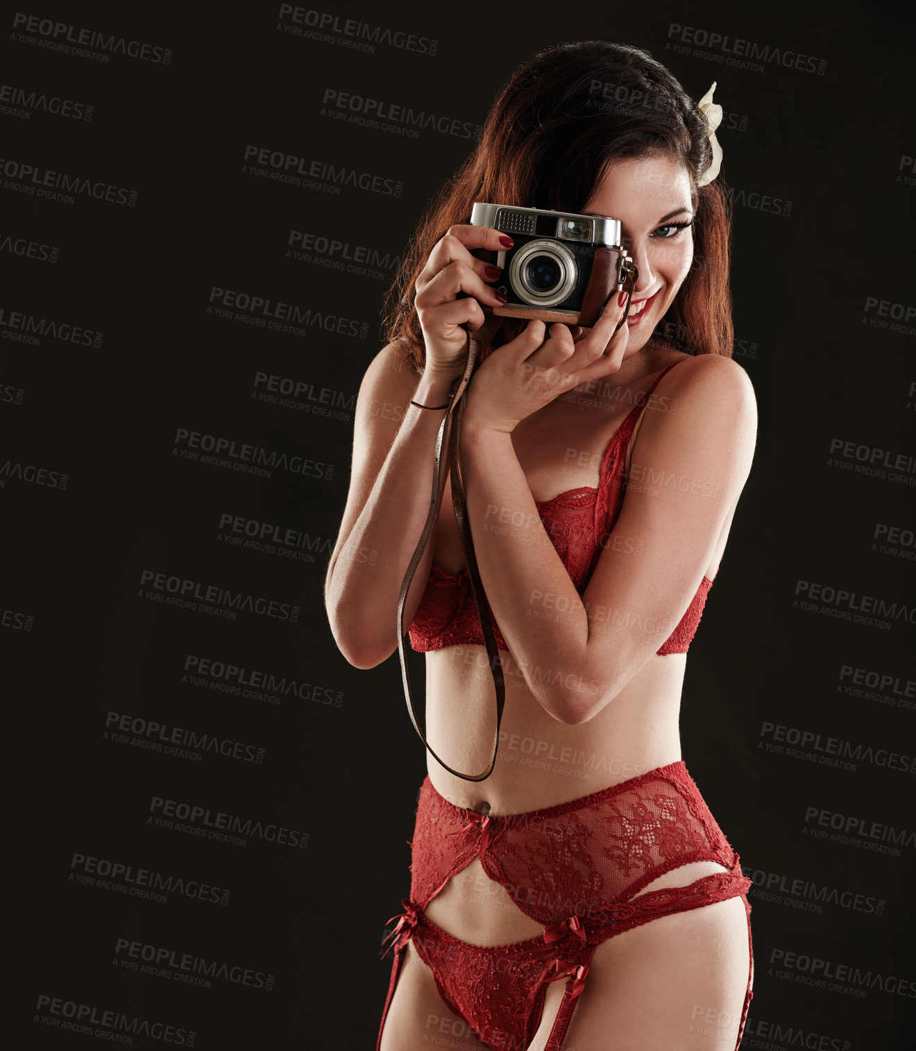Buy stock photo Portrait, red lingerie and woman with a camera, smile and model on a dark studio background. Face, person and girl with photography and underwear with picture and memory with confidence and sensual