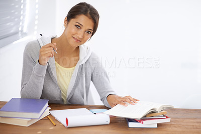 Buy stock photo A pretty young university student studying for her finals in her dorm room