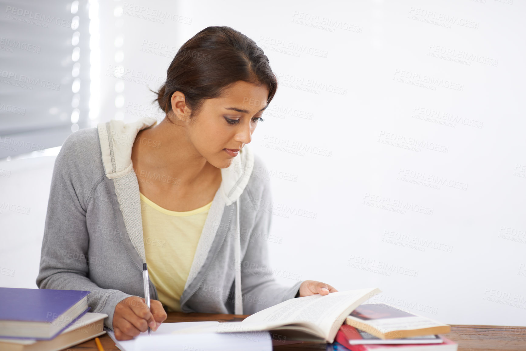 Buy stock photo Student, woman and writing with books for study, knowledge or education with notes for project in dorm room. Young person, girl and learning at desk with novel for scholarship, reading and assessment