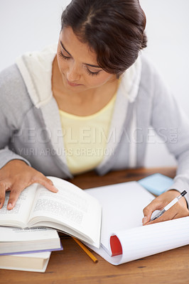 Buy stock photo Reading, woman writing and student studying in college, learning and work on school project at desk. Books, serious person at table and education, knowledge and info for test on notepad in university
