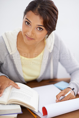 Buy stock photo Portrait, writing and student studying in college, learning and reading for school project at desk. Face, books and woman at table for education, knowledge and info for notes in university in Brazil