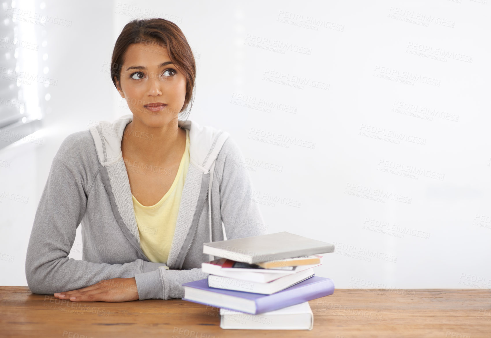 Buy stock photo Woman, student or thinking with books by desk, idea or learning for research of assignment. Young person, indian and thought by notebook on scholarship, studies and planning for test study in college