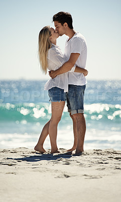 Buy stock photo Couple, beach kiss and hug with love, support and care on a date by the sea with romance on vacation. Holiday, ocean and outdoor with summer travel in nature relax on a break and trip by the water