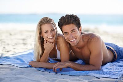 Buy stock photo Love, portrait and couple on blanket at beach for date, outdoor bonding or tropical holiday. Romance, man and woman at sea, picnic and relax on ocean vacation together with travel, care and adventure