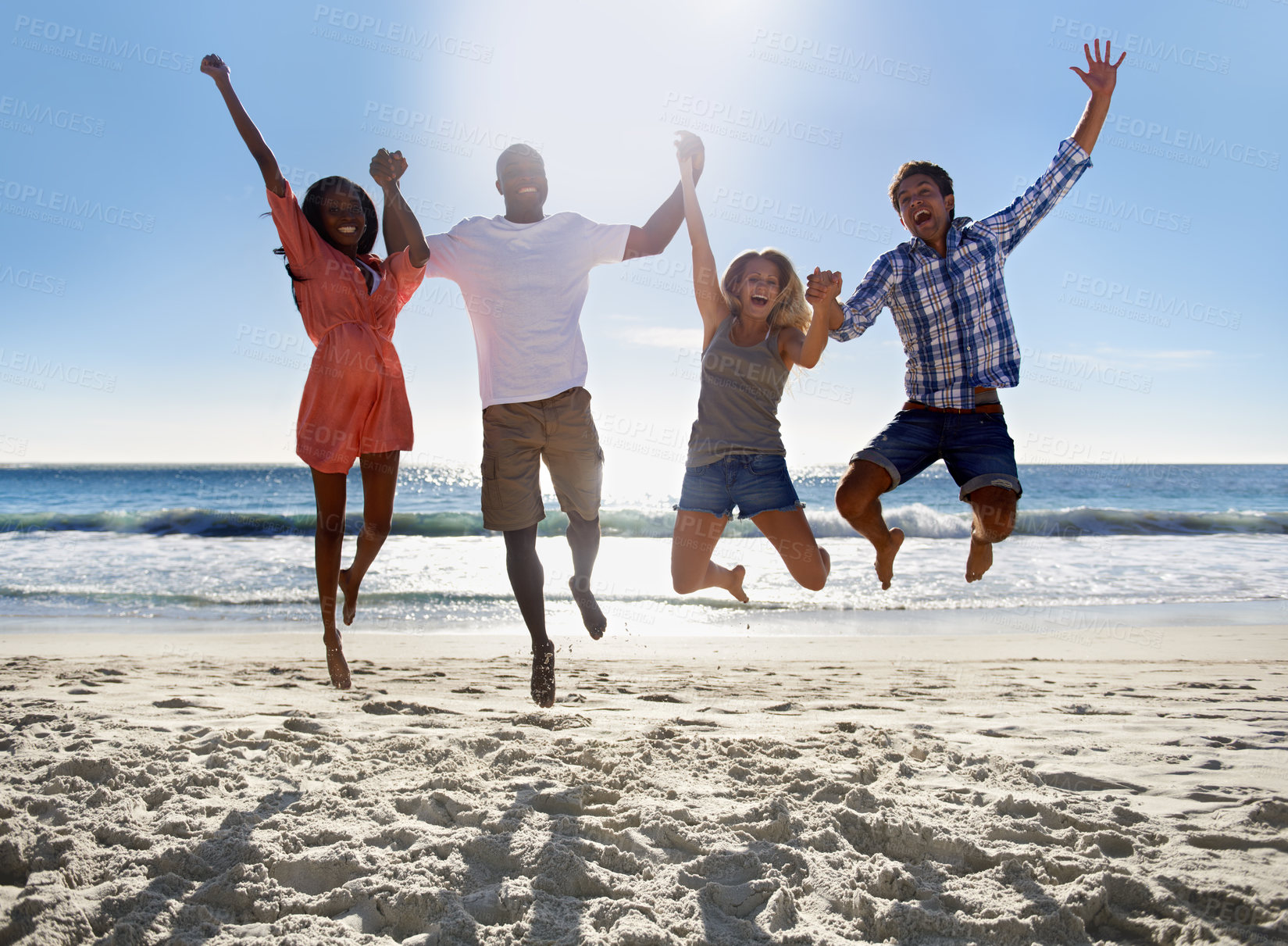 Buy stock photo Two young couples jumping and having fun together on the beach