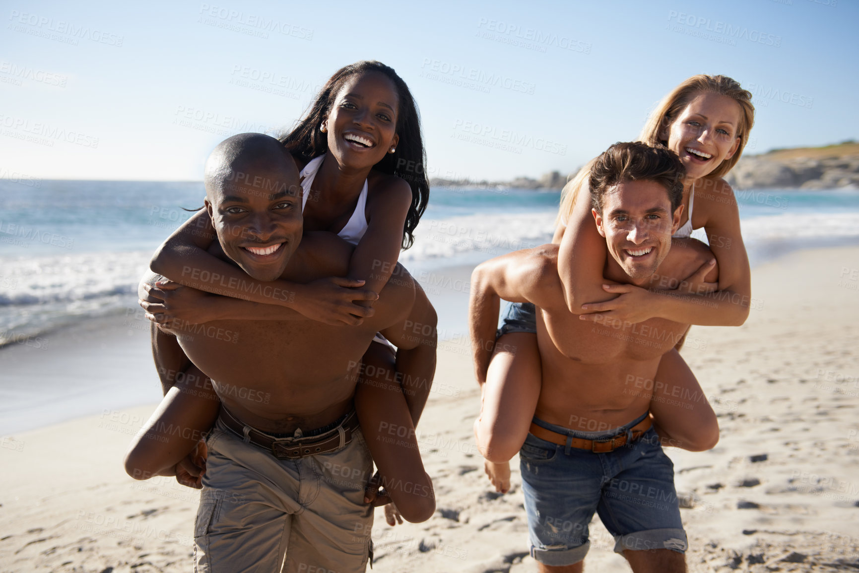 Buy stock photo Two young couples enjoying the sun on the beach together