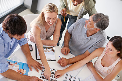 Buy stock photo A group of designers having a brainstorming session around a table