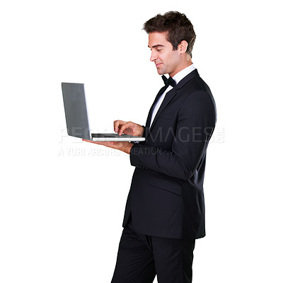 Buy stock photo Male waiter, typing and laptop with service and suit in white background is working at restaurant. Butler, bowtie and technology with man in hospitality with tuxedo, luxury and menu in studio.