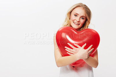 Buy stock photo Woman, portrait and heart balloon for love in studio, happy and valentines day in casual fashion. Model, positive and face by red care symbol, affection and wellness in mockup by white background