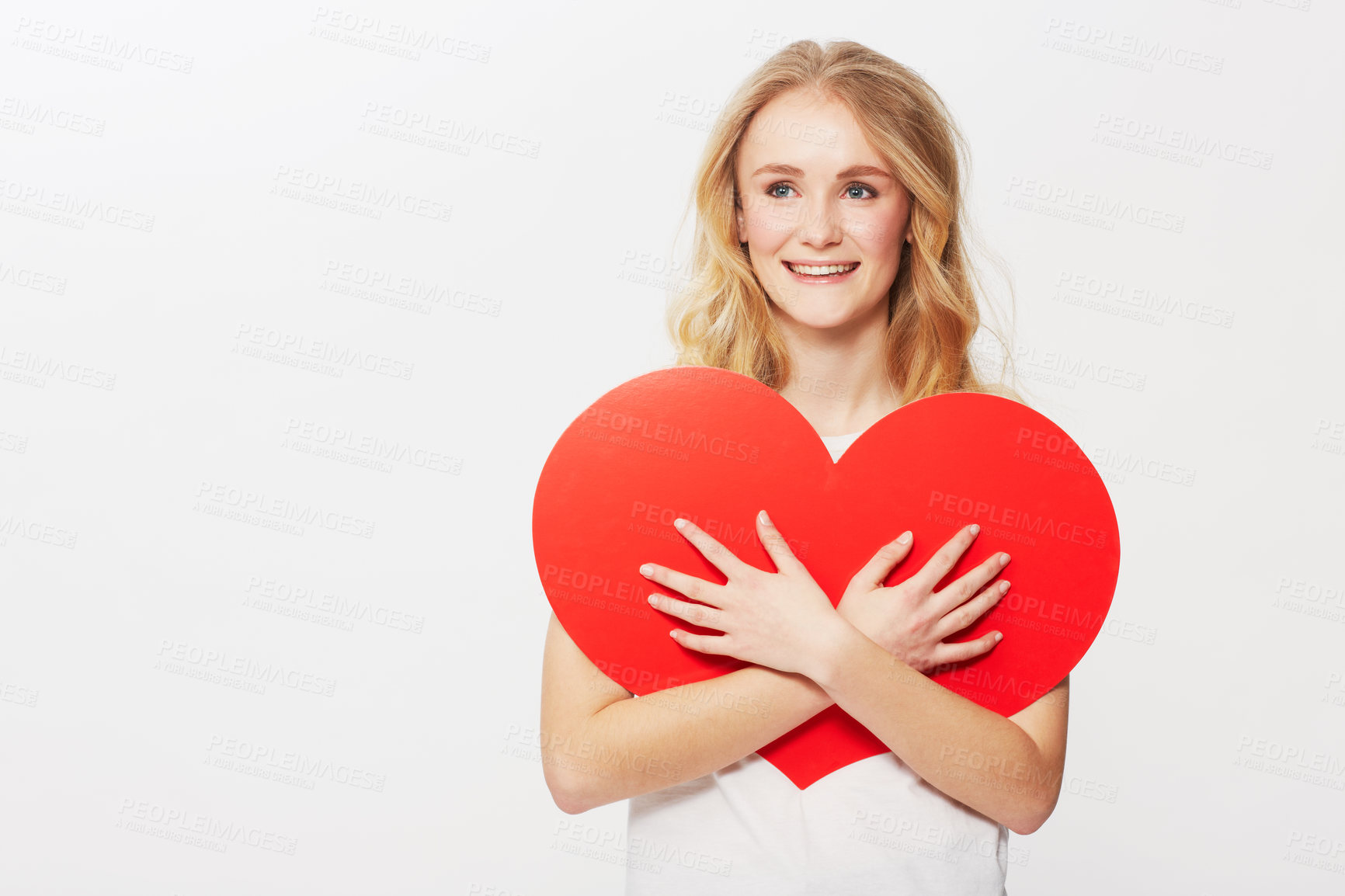 Buy stock photo Young woman, red heart or happiness in studio for wellness, love or romantic review on valentines day. American model, positive and smile with care symbol for support and opinion by white background