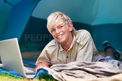 Buy stock photo Child, boy and happy with laptop in tent for camping, social media and online movie with portrait in nature. Person, face and kid with smile outdoor on grass for gaming, vacation and holiday fun