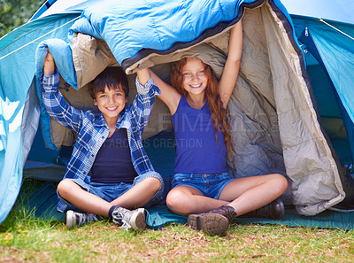 Buy stock photo Portrait of a young brother and sister sitting inside their tent