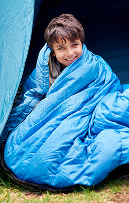 Buy stock photo Boy in portrait, child in sleeping bag and camping, relax in tent and summer vacation with travel and portrait outdoor. Happy, young kid with smile and adventure in nature, childhood and recreation