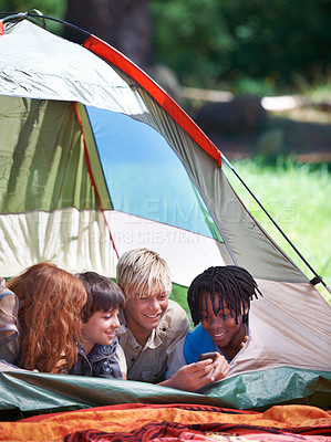 Buy stock photo Friends, camping and happy of children in tent for resting, relaxing and bonding with cellphone. Travel gear, smile and young girls and boys for adventure on holiday, vacation and weekend outdoors