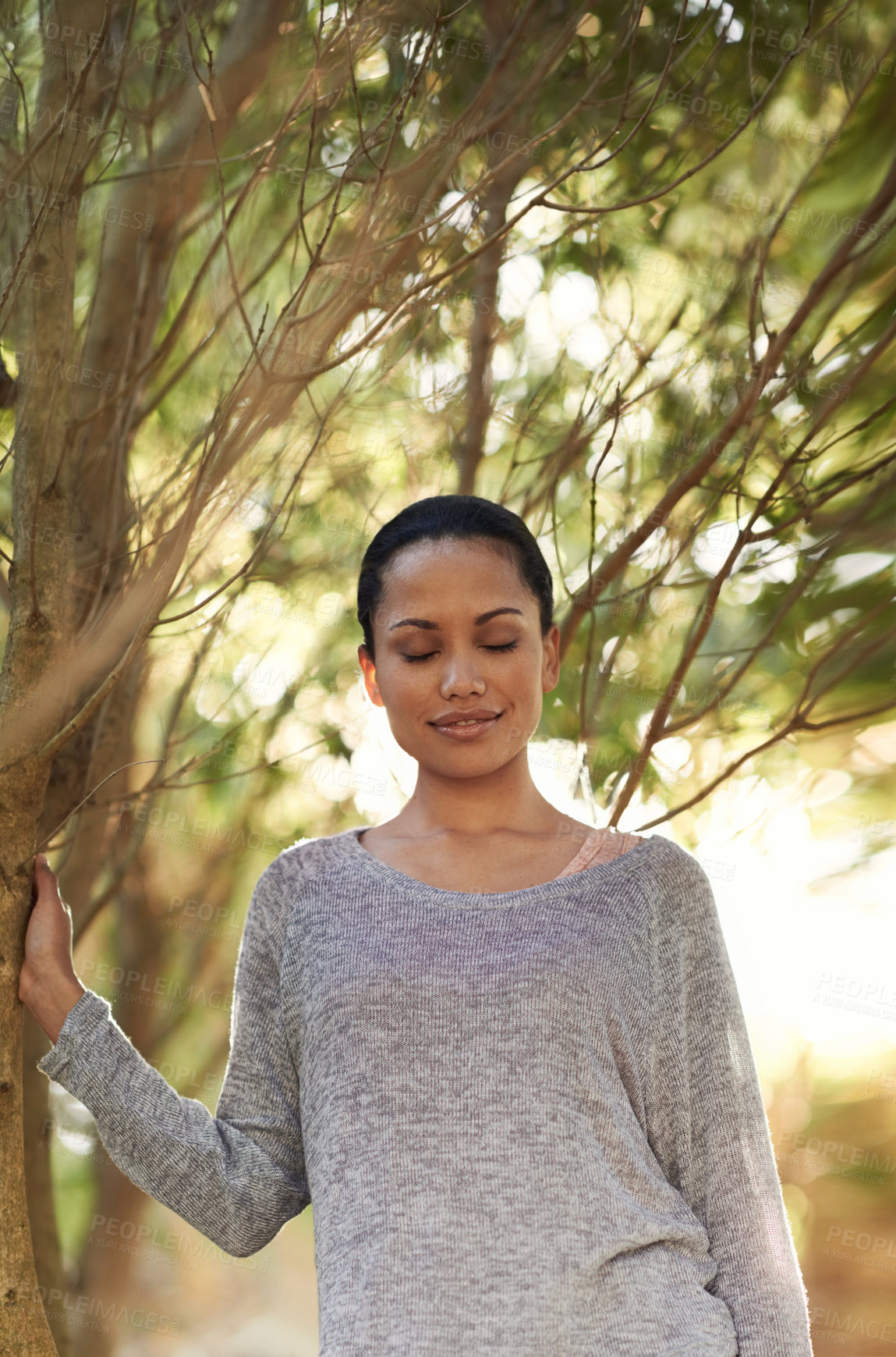 Buy stock photo Woman, tree and eyes closed for peace in woods, travel and thinking about life, mindfulness and sunshine. Forest, nature and calm outdoor, zen and dream in environment with tranquility and fresh air