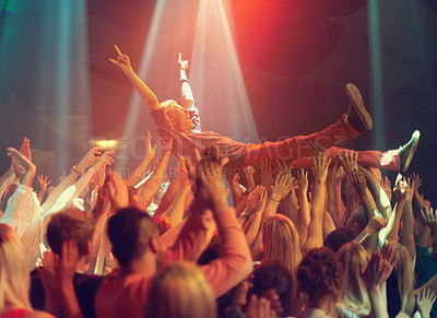Buy stock photo A young man crowd surfing to his favorite band. This concert was created for the sole purpose of this photo shoot, featuring 300 models and 3 live bands. All people in this shoot are model released.