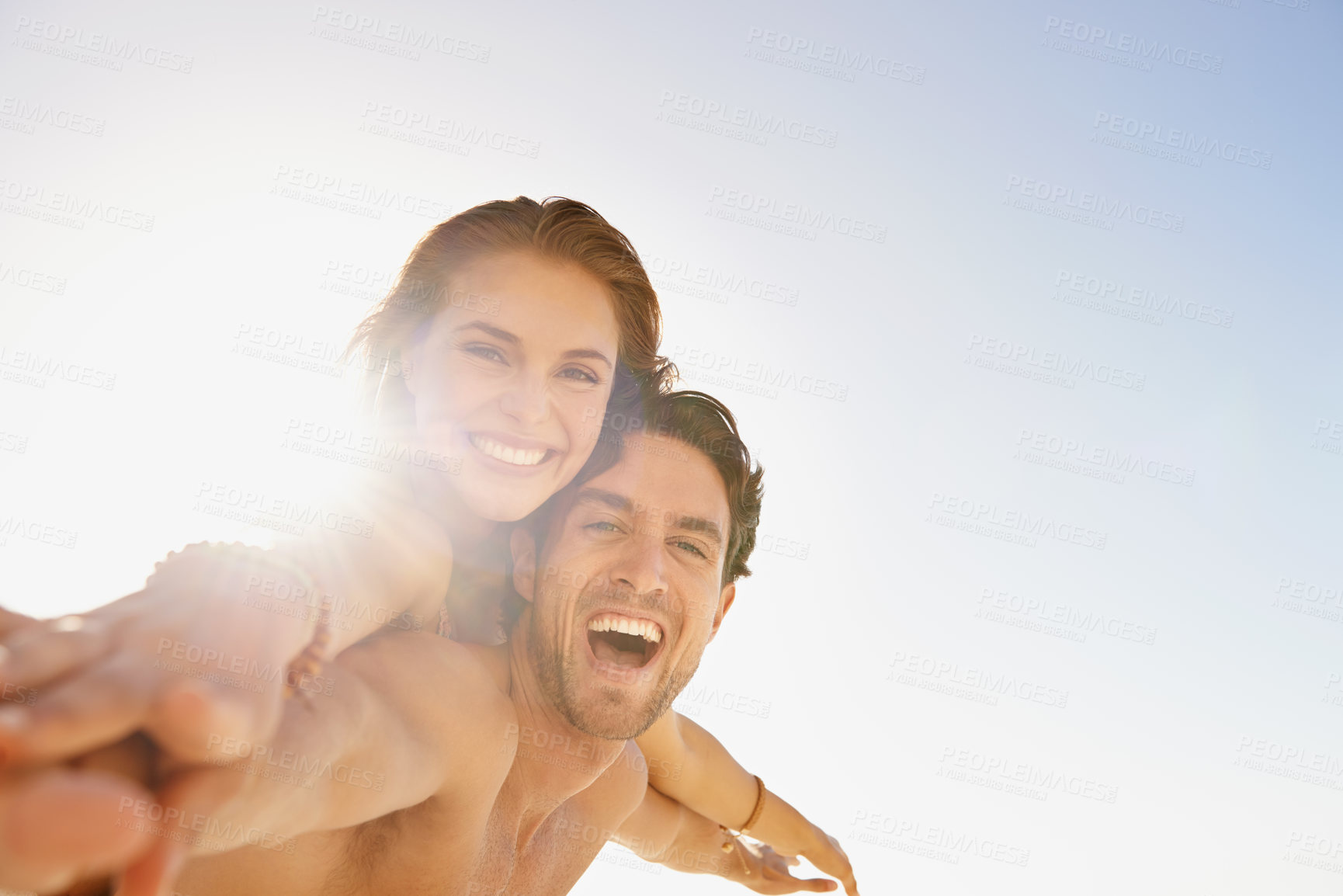 Buy stock photo Happy couple, portrait and piggyback in support with blue sky at beach in love, care or enjoying outdoor holiday weekend. Face of man and woman smile for fun embrace, trust or hug in summer on mockup