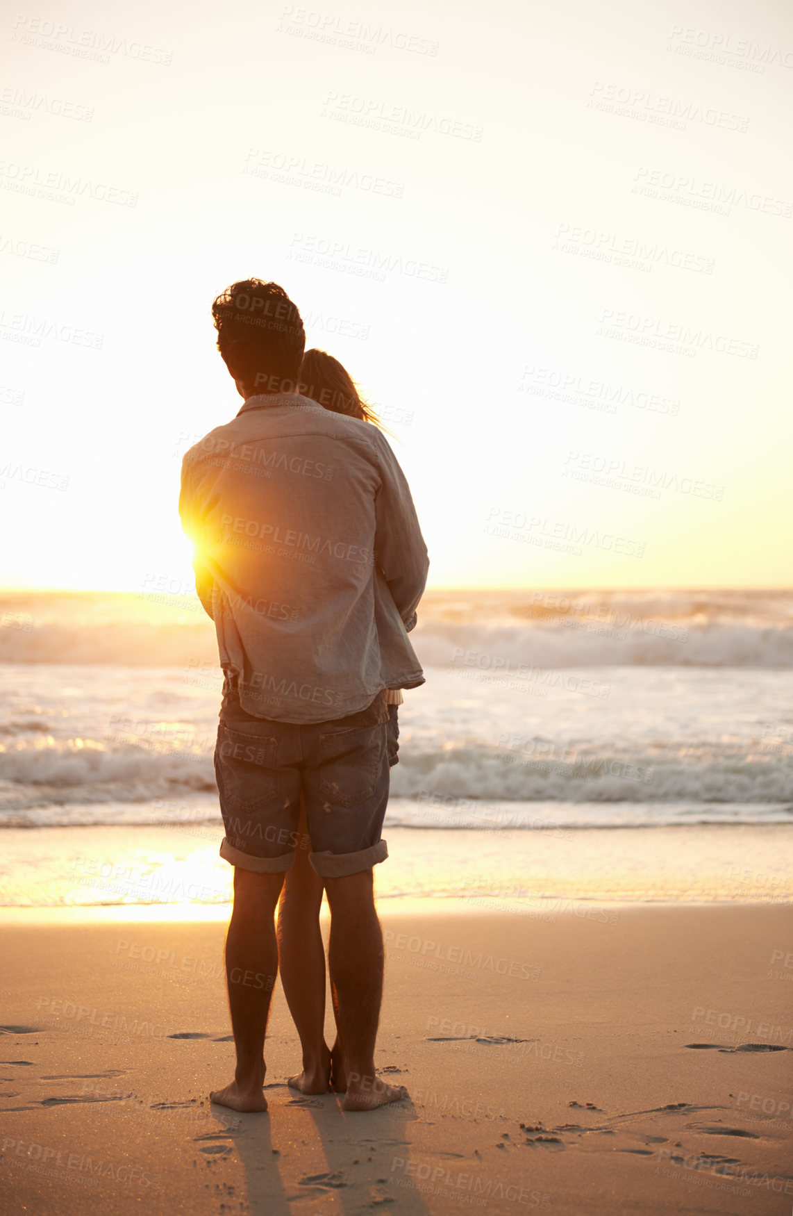 Buy stock photo Man, woman and beach hug at sunset for summer travel or adventure, bonding or marriage. Happy couple, embrace and sea water for dating tourism or back view for nature vacation, environment or holiday