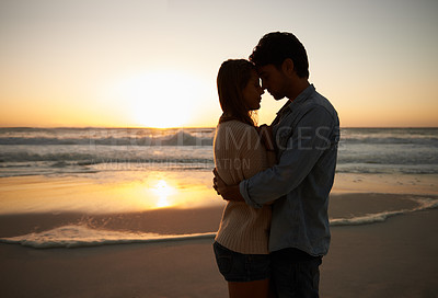 Buy stock photo Couple, sunset and hugging on beach vacation, love and bonding on trip to ocean at dusk. People, embrace and romance on outdoor adventure at sea, peaceful environment and commitment in marriage