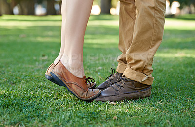 Buy stock photo Cropped shot of a young girl standing tiptoe on her boyfriend's feet