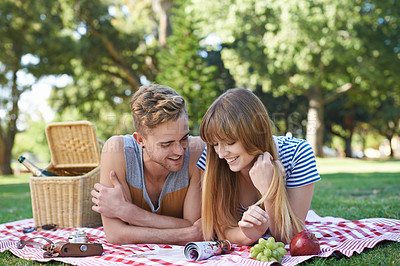 Buy stock photo Picnic, love and couple on blanket in park for bonding, relationship and relax on date outdoors. Happy, dating and man and woman on grass with food for lunch, meal and eating in nature for romance
