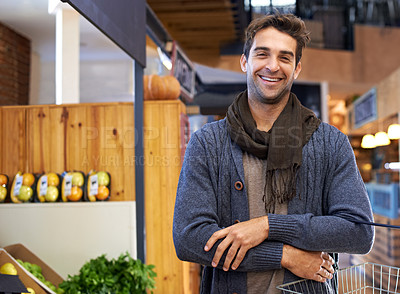 Buy stock photo Portrai tof a young man shopping in a supermarket